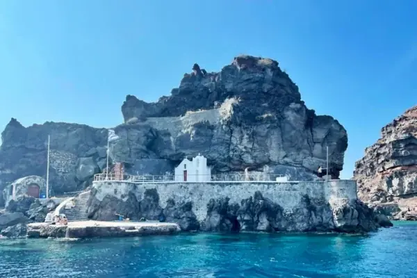 The white chapel of St. Nicholas on its rocky islet off Oia, Santorini