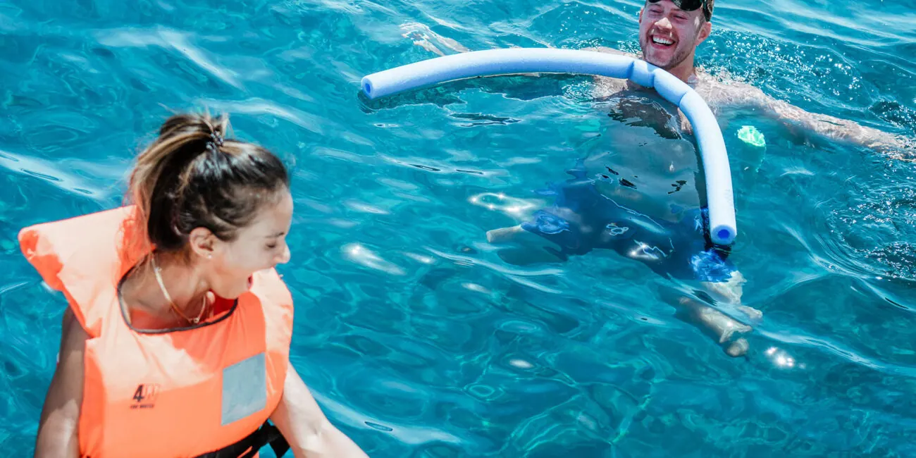 Life vests on and into the clear Aegean — a swim stop from our catamaran