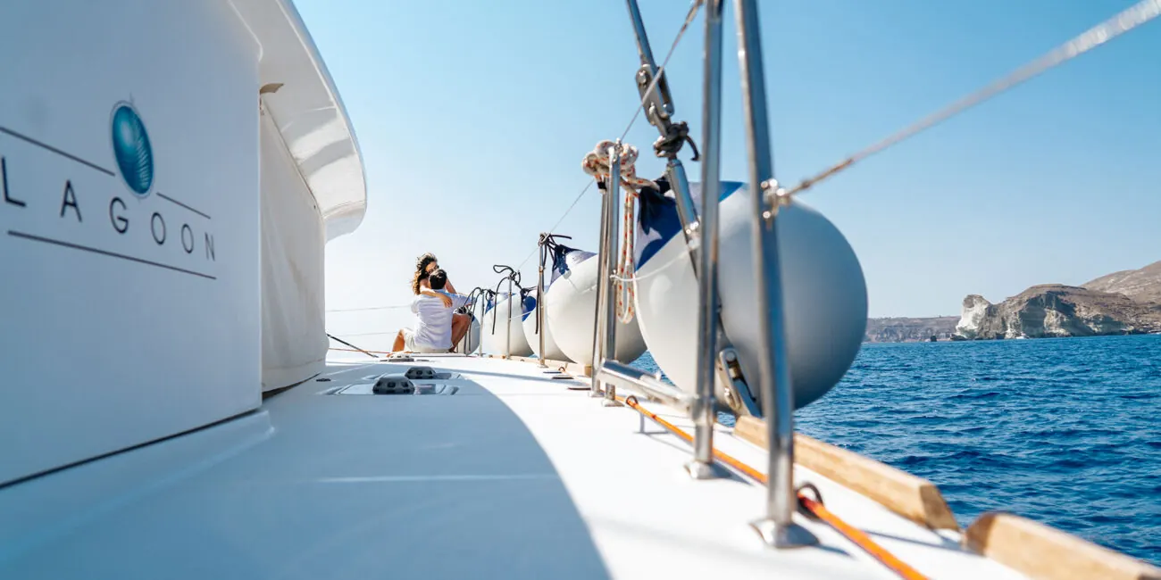 On the deck of the Sirigos Sailing Lagoon catamaran off Santorini's south coast
