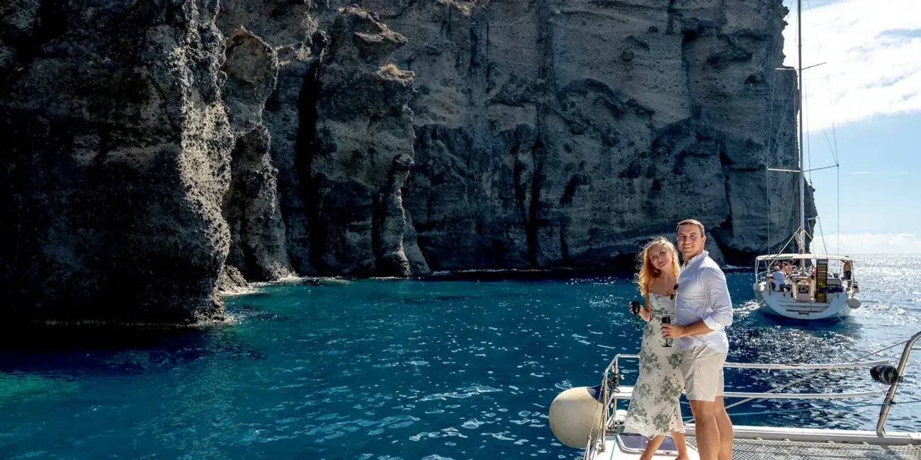Our catamaran anchored below the volcanic cliffs of Santorini