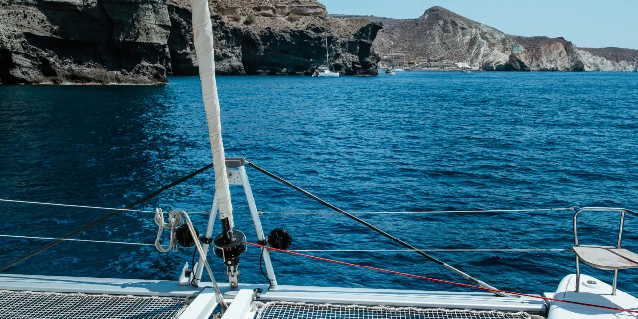 Relaxing on the bow trampoline during a Sirigos Sailing catamaran cruise
