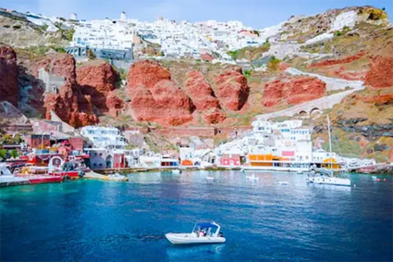 A small boat in Ammoudi Bay below Oia — on-demand boat service in Santorini