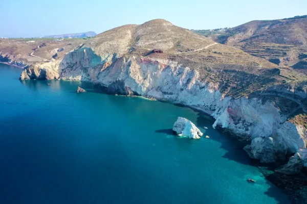 The white pumice cliffs and cove of White Beach, Santorini, from above the water